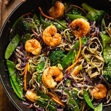 top down view of prawn noodle stir fry in a wok