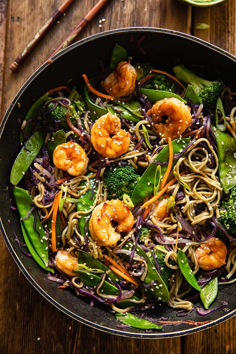 top down view of prawn noodle stir fry in a wok