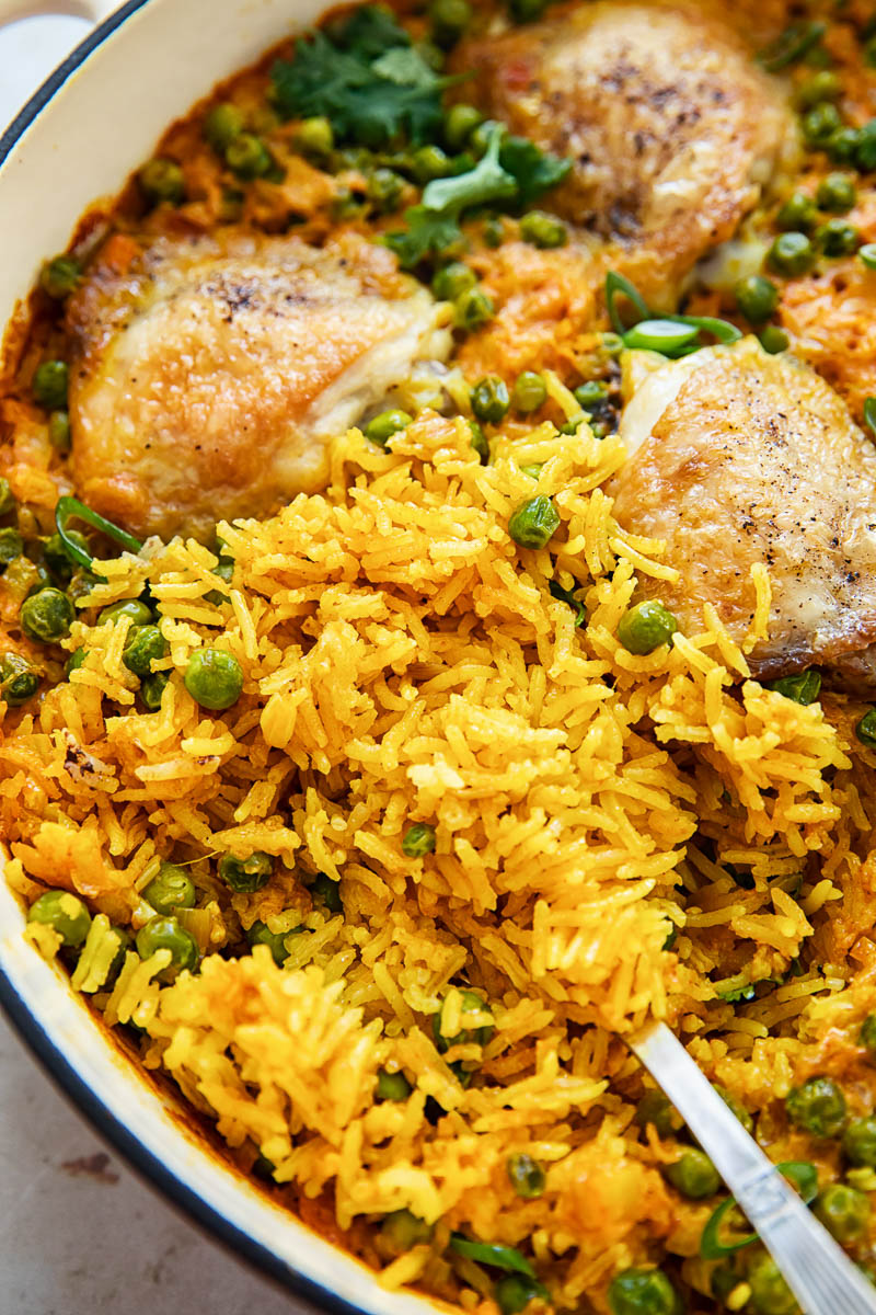 close up of yellow Basmati rice with chicken cooked in a pan