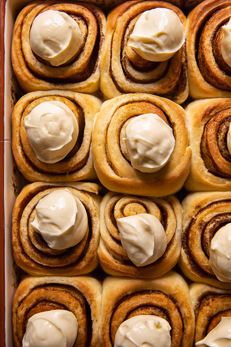 cinnamon rolls with dollops of icing on top