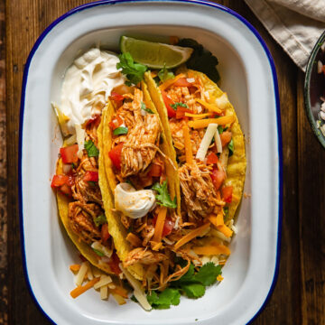 top down view of chicken tacos in a white dish