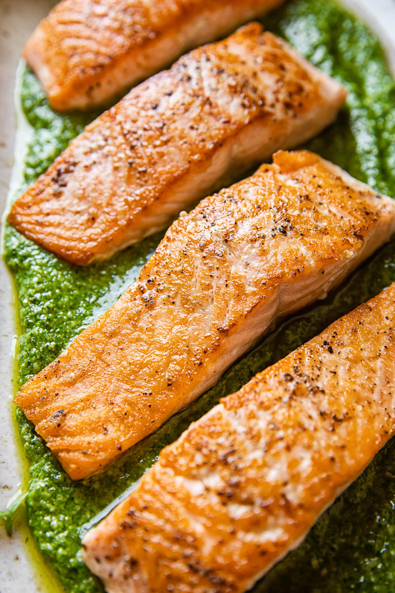 pan fried salmon fillet on top of basil pesto