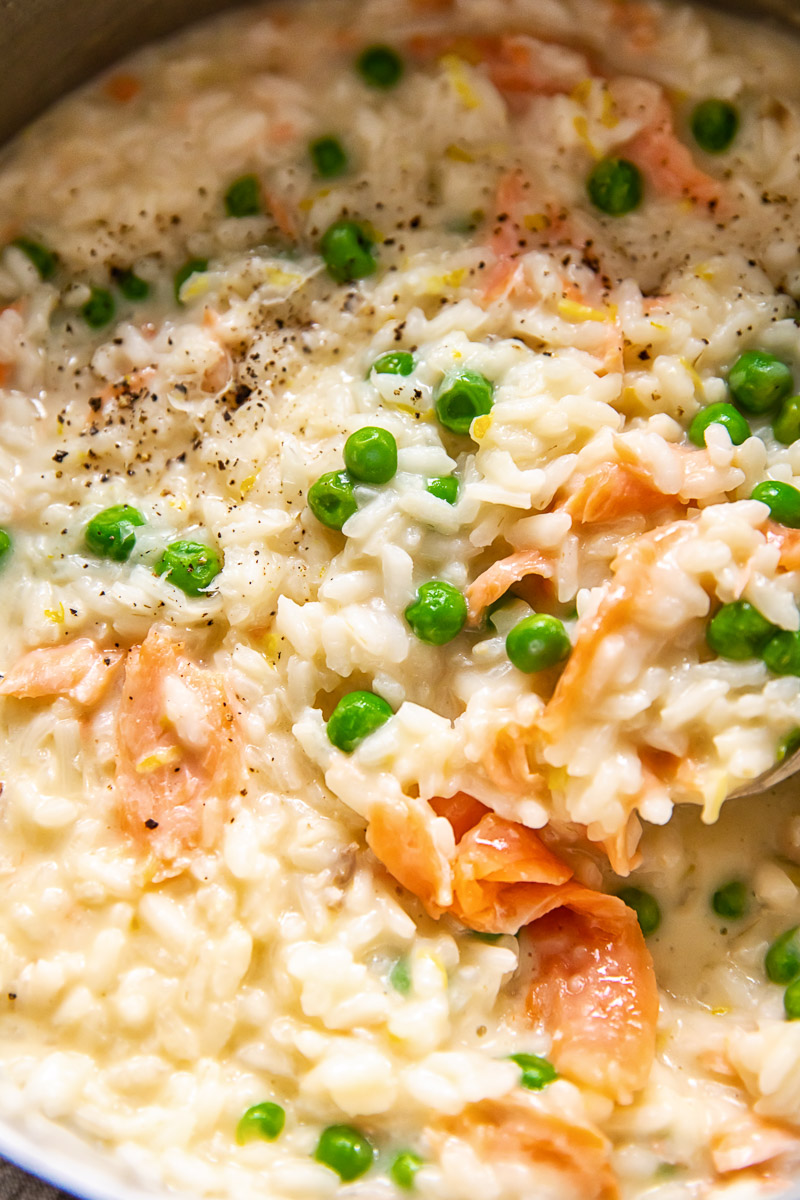 close up of smoked salmon risotto with green peas
