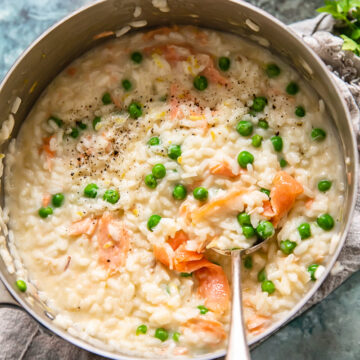 top down view of salmon and pea risotto in a pan