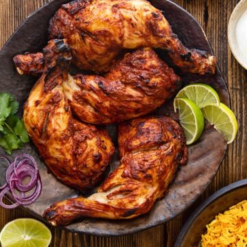 top down view of chicken legs on a brown platter