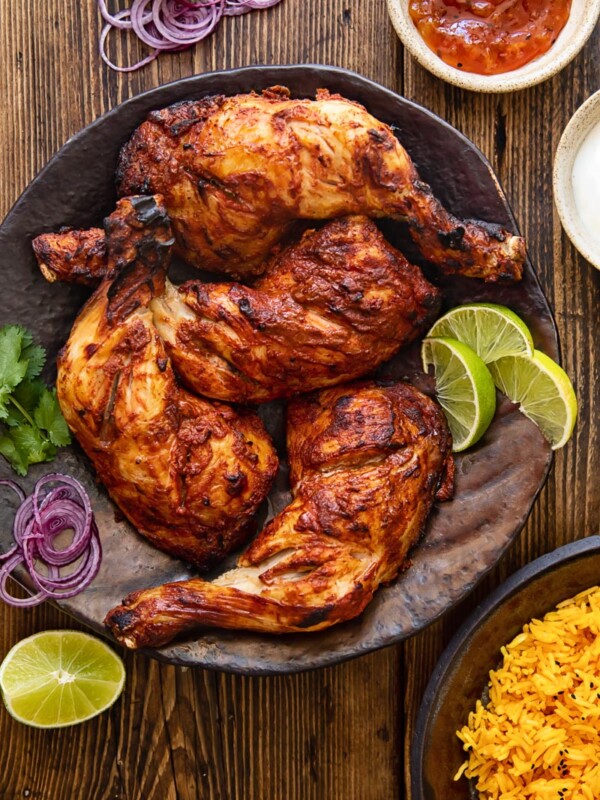 top down view of chicken legs on a brown platter
