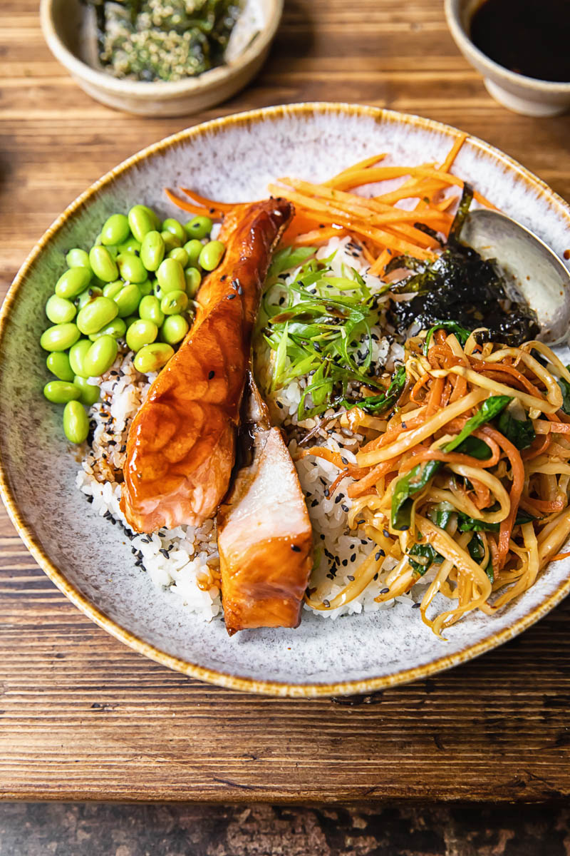 teriyaki salmon with rice and vegetables in a bowl