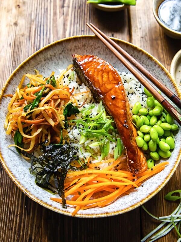 salmon, vegetables and edamame beans on top of rice