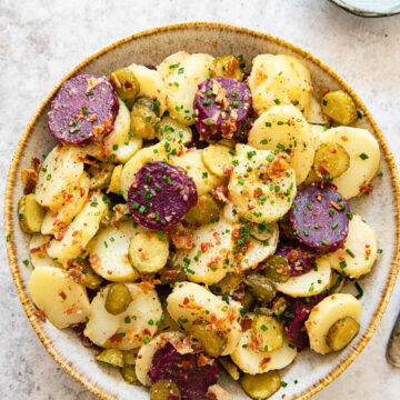 top down view of potato salad with white and purple potatoes