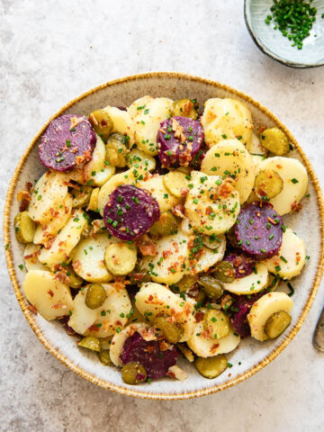 top down view of potato salad with white and purple potatoes