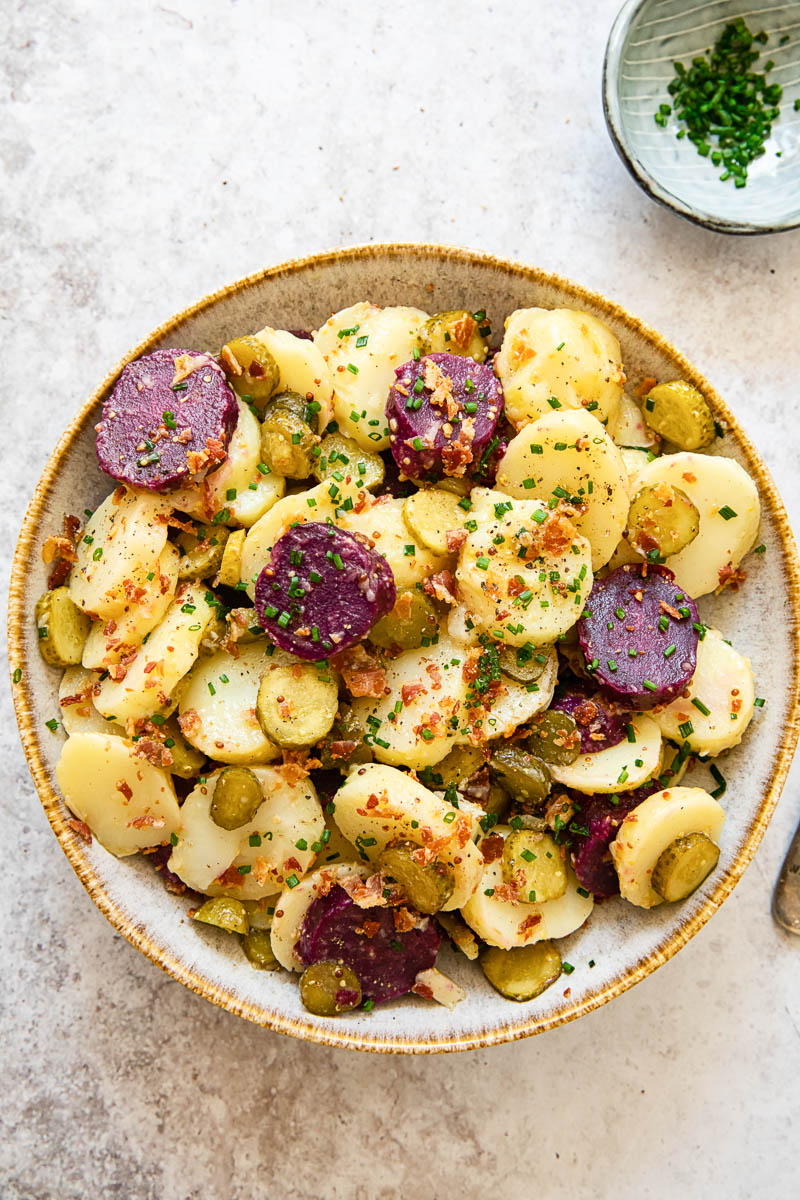 top down view of potato salad with white and purple potatoes