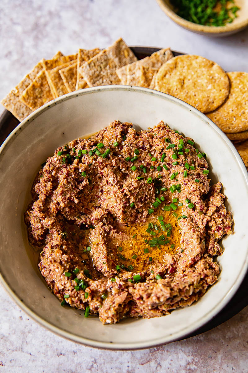 top down view of olive tapenade with crackers