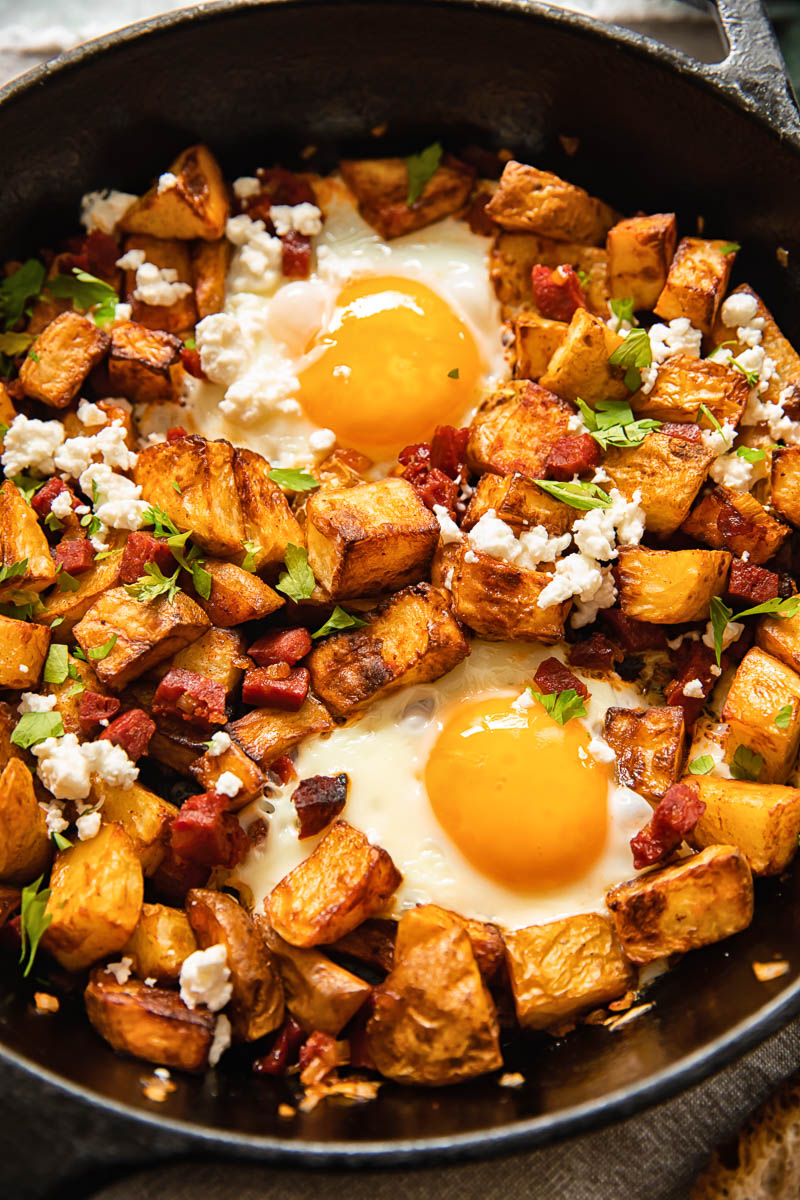 breakfast skillet with fried potatoes, eggs, chorizo and feeta