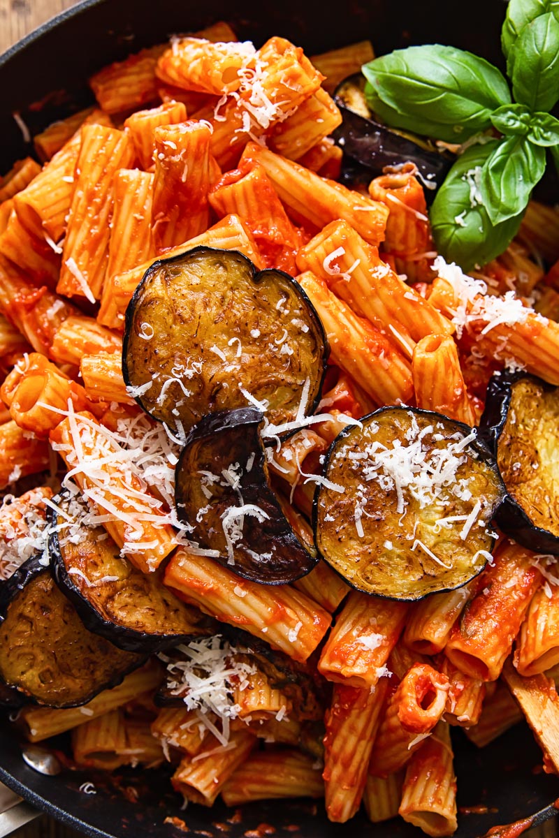 close up of pasta in tomato basil sauce with fried aubergine on top