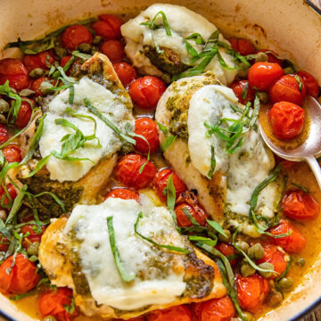 chicken caprese in a pan with cherry tomatoes