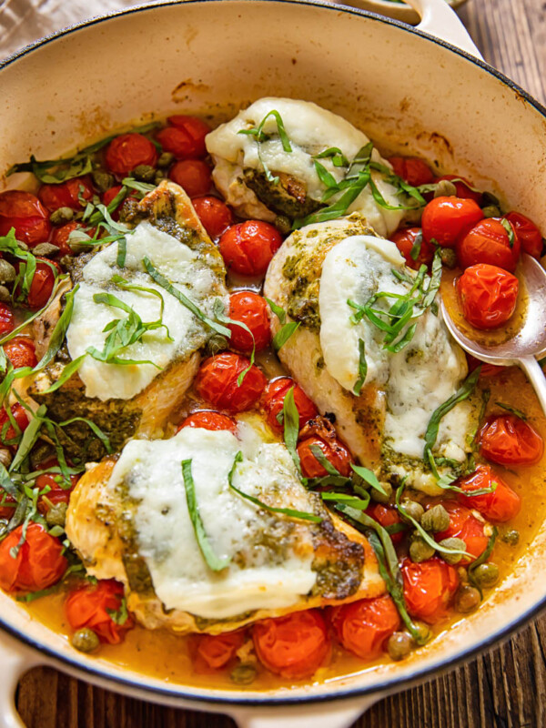 chicken caprese in a pan with cherry tomatoes
