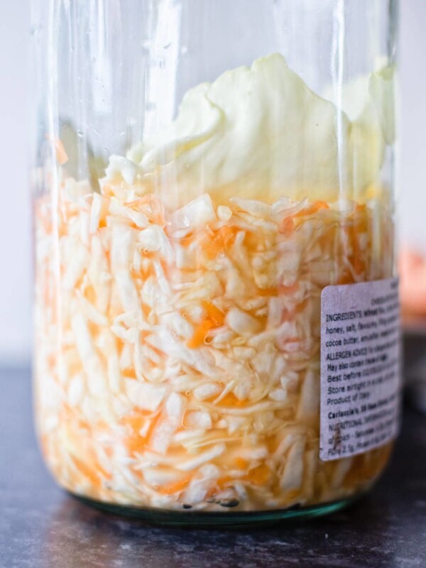 fermented cabbage and carrots in a large glass jar