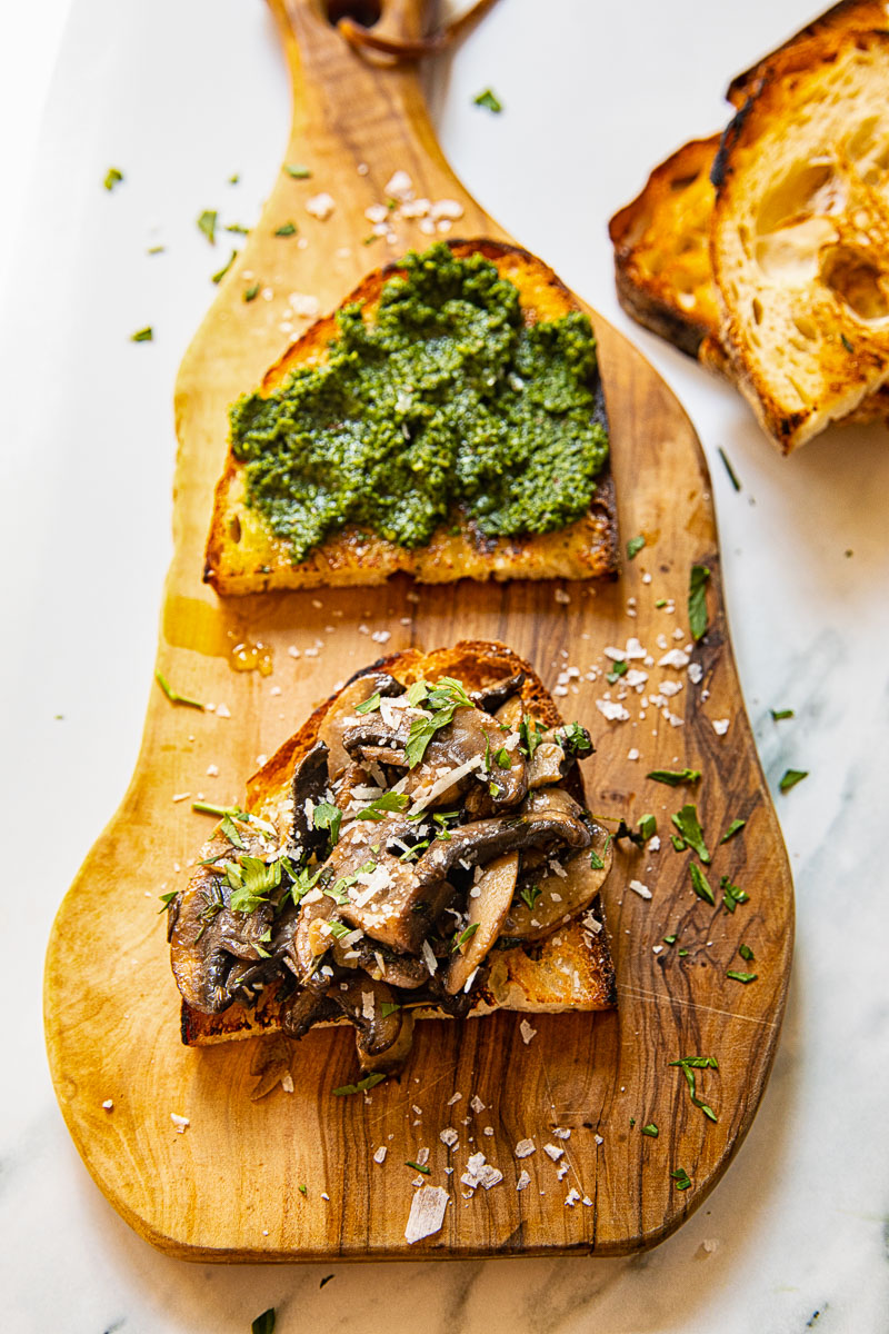 top down view of crostini on wooden board