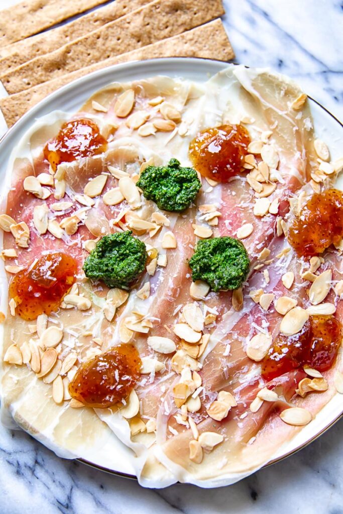 top down view of Parma ham topped with pesto, fig jam and almonds