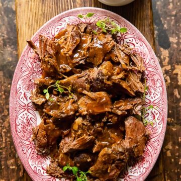 top down view of lamb in red wine sauce on a platter