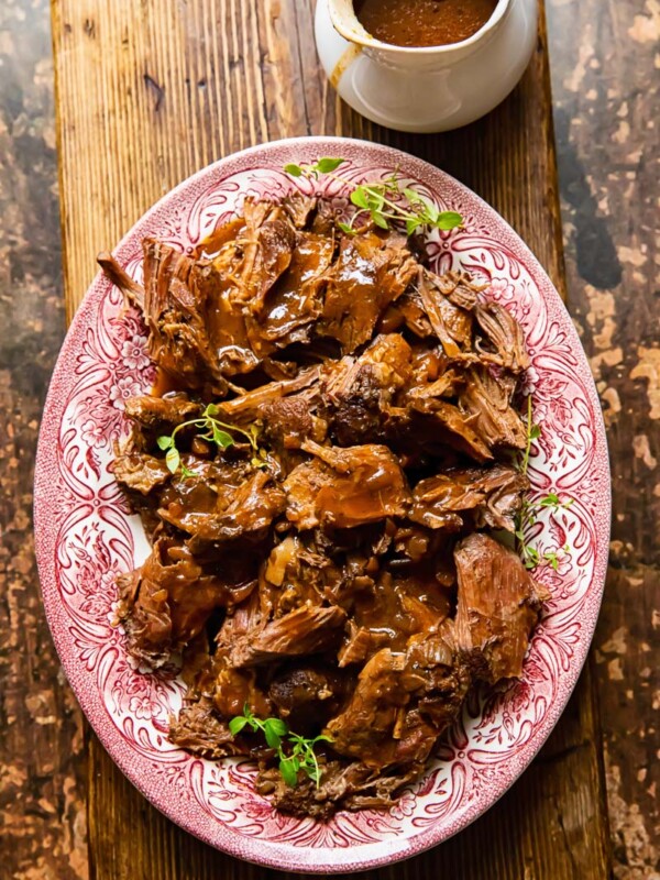 top down view of lamb in red wine sauce on a platter