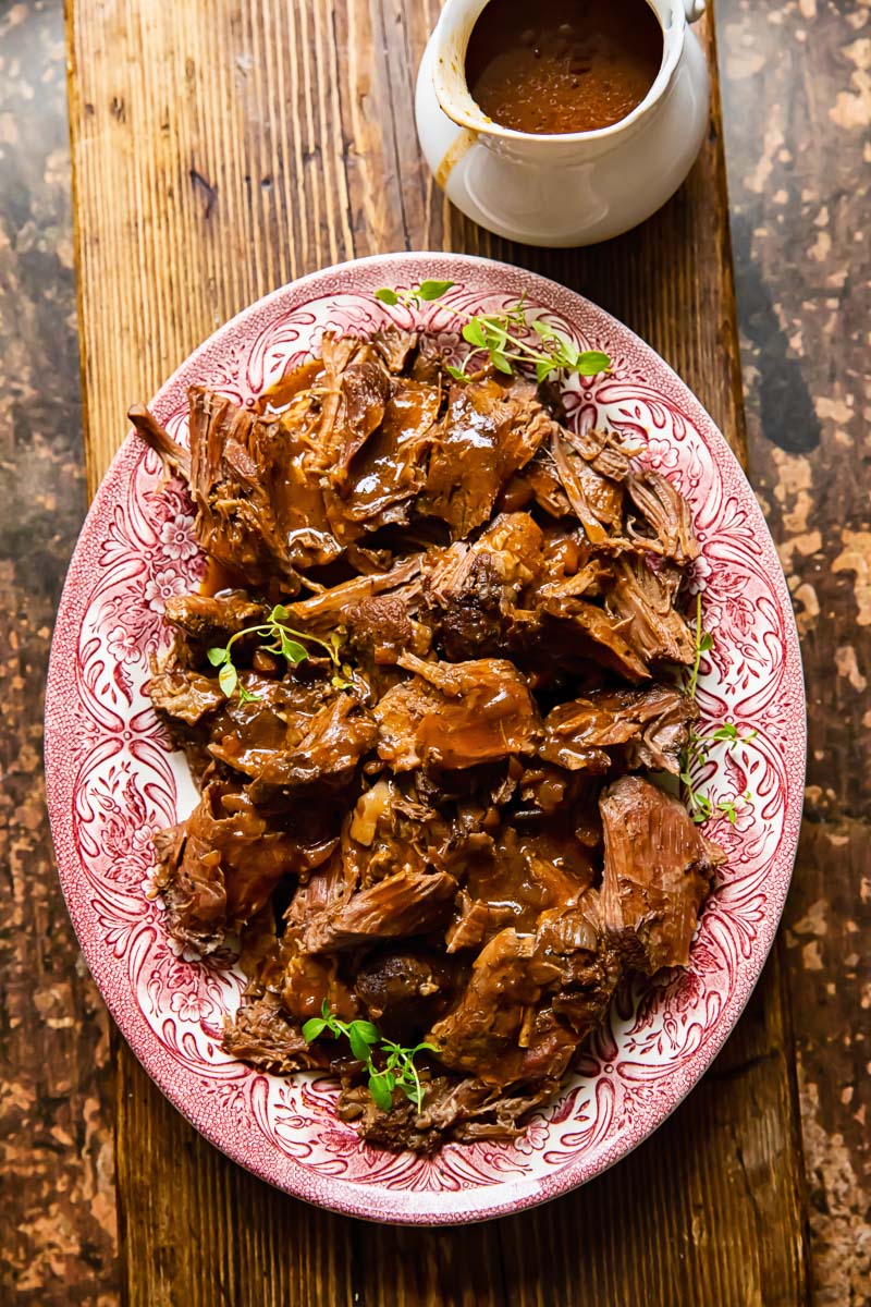 top down view of lamb in red wine sauce on a platter