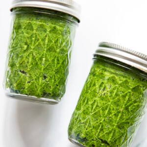 two mason jars filled with green pesto