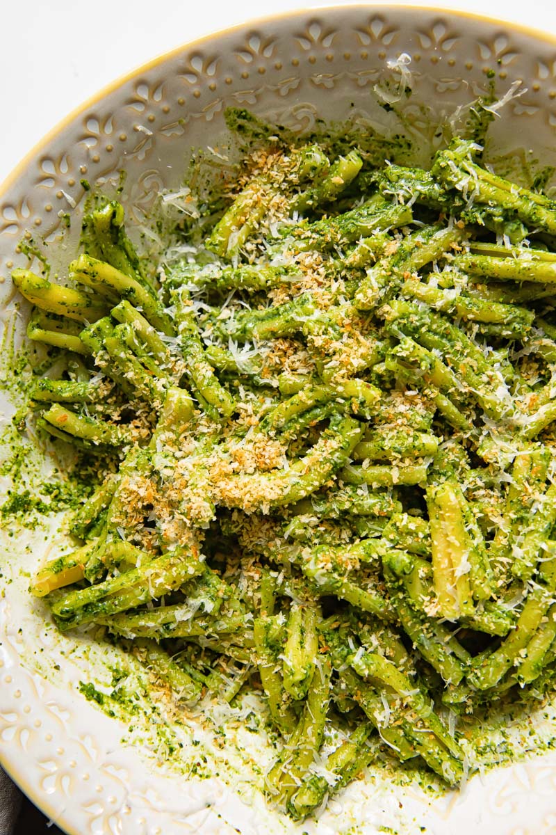 top down view of kale pesto pasta with breadcrumbs