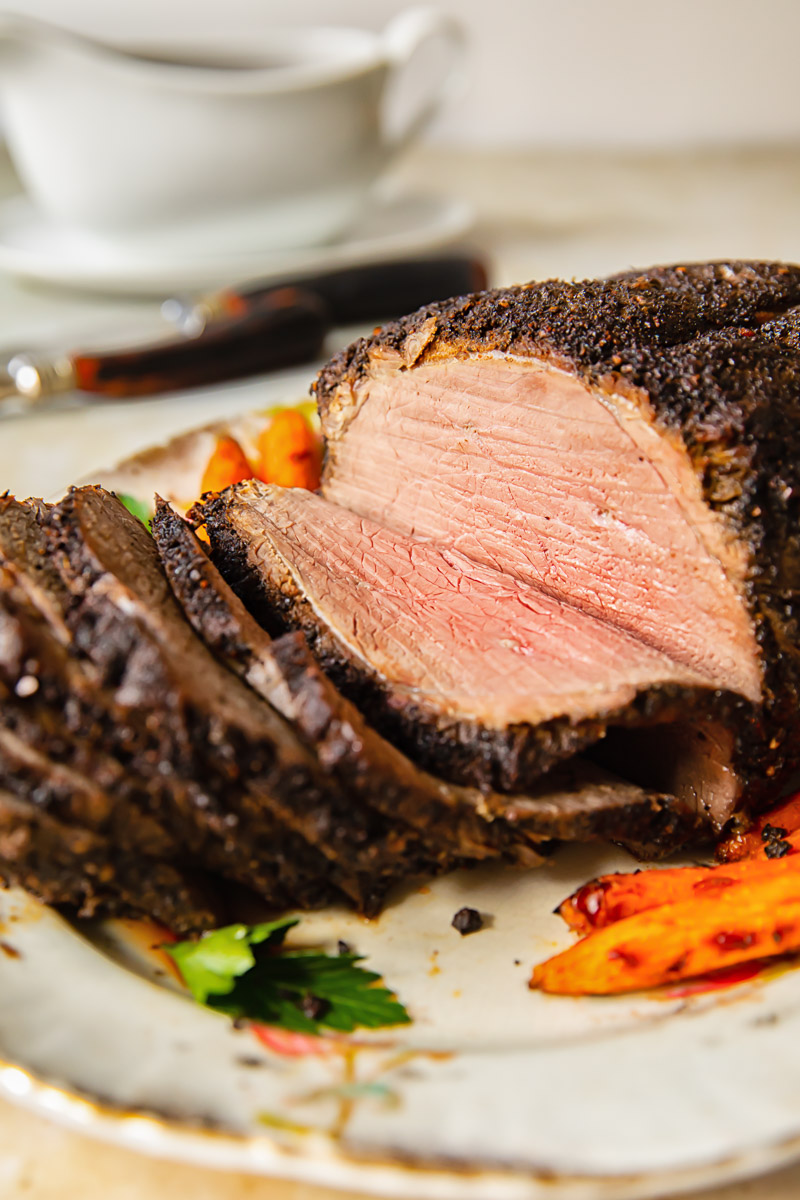 side view of sliced roast beef on a platter