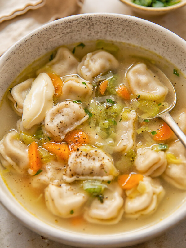 top down view of a bowl of soup with dumplings and vegetables
