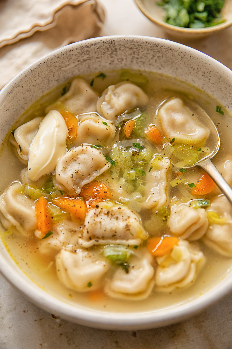 top down view of a bowl of soup with dumplings and vegetables