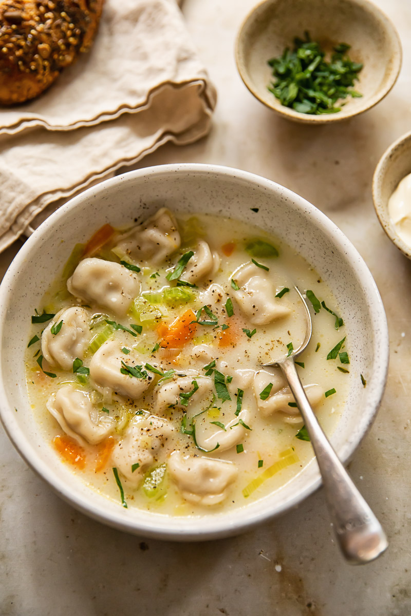 pelmeni soup in a bow with a spoon