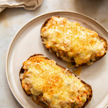 Hot cheesy salmon sandwiches on a plate