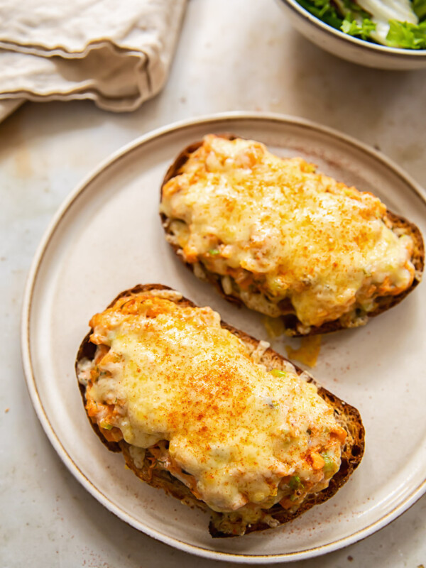 Hot cheesy salmon sandwiches on a plate