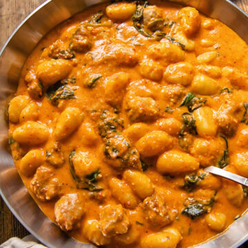 top down view of gnocchi with romesco sauce in a pan