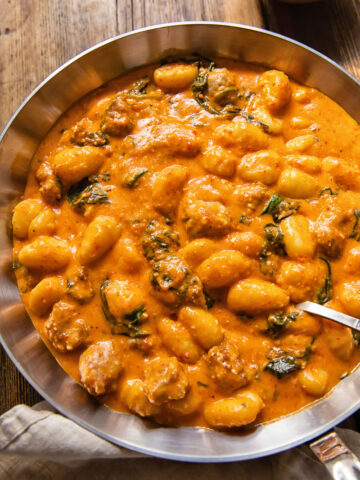 top down view of gnocchi with romesco sauce in a pan