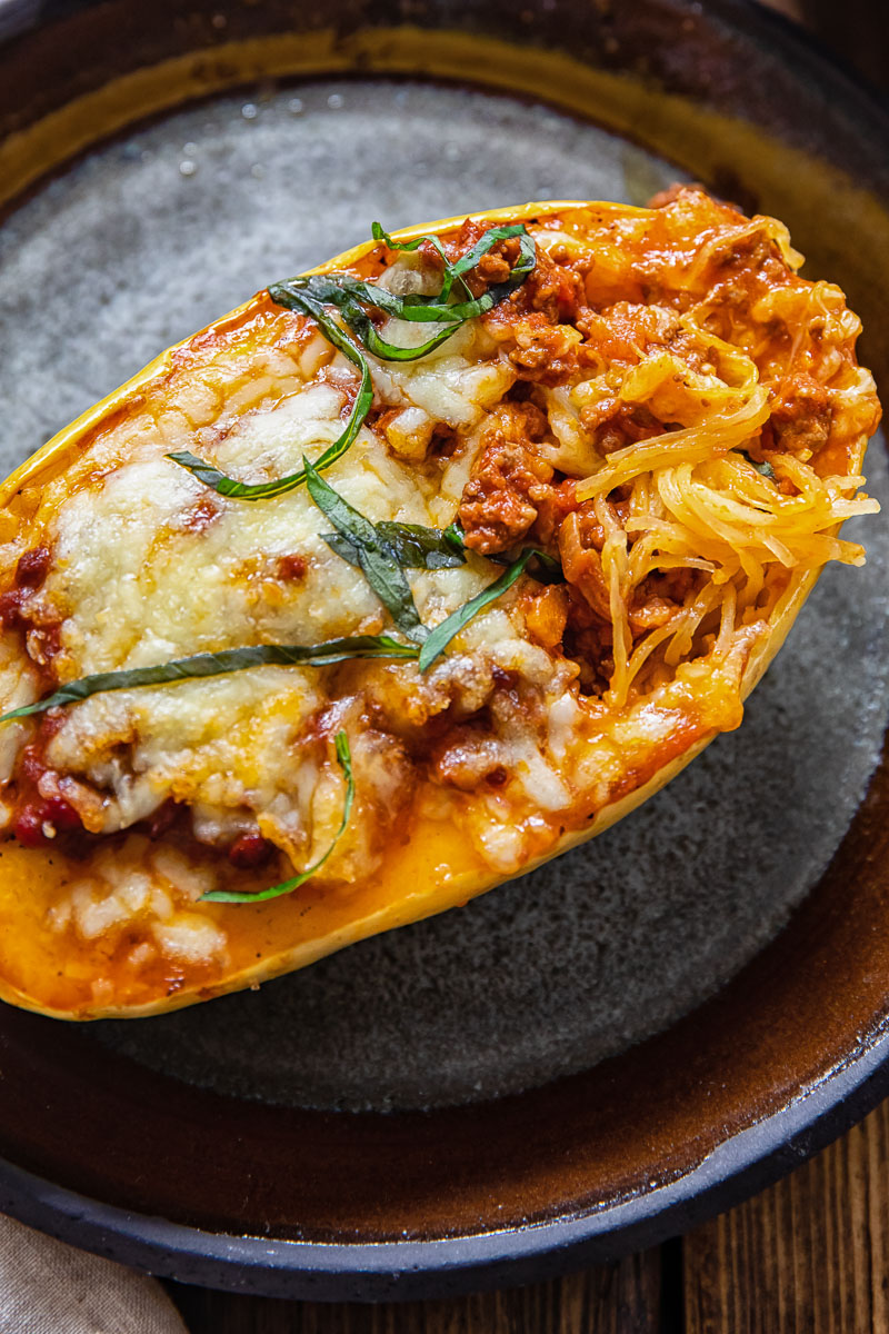 spaghetti squash on a plate with strands of flesh poking through