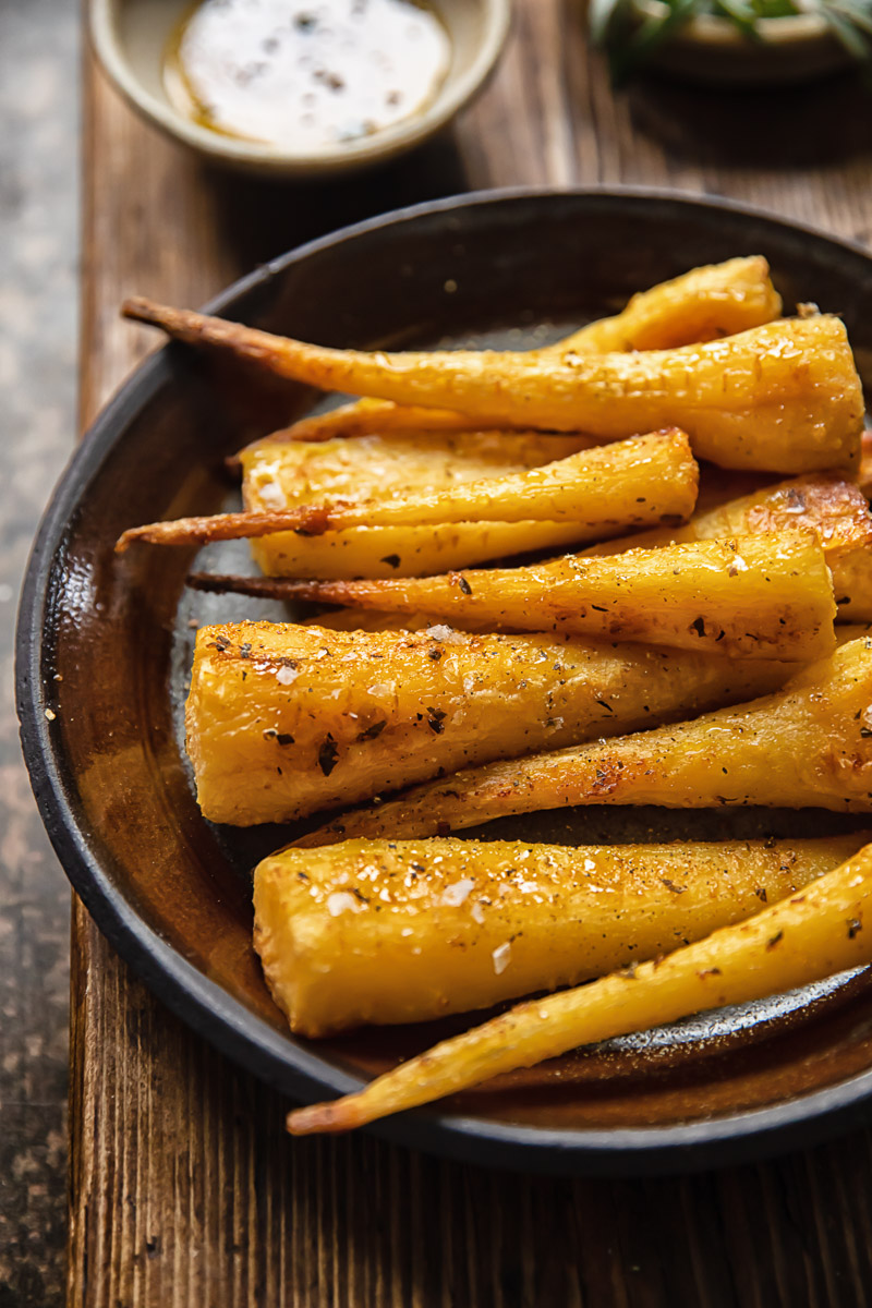 roast parsnips on brown plate