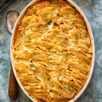 top down view of scalloped potatoes in an oval pan