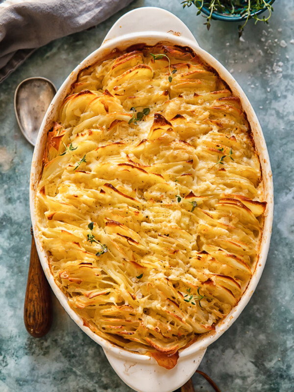 top down view of scalloped potatoes in an oval pan