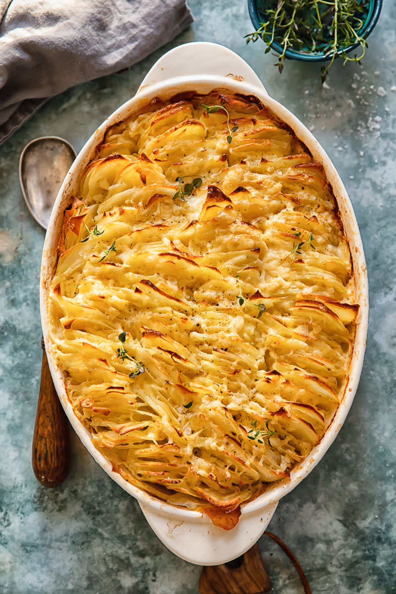 top down view of scalloped potatoes in an oval pan