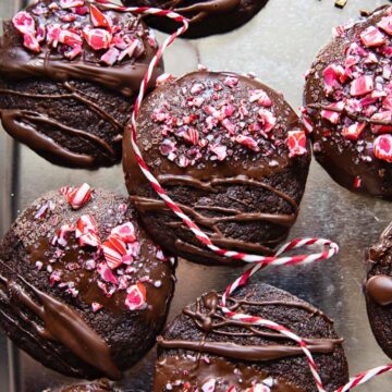 top down view of chocolate cookies drizzled with chocolate and top with crushed candy cane