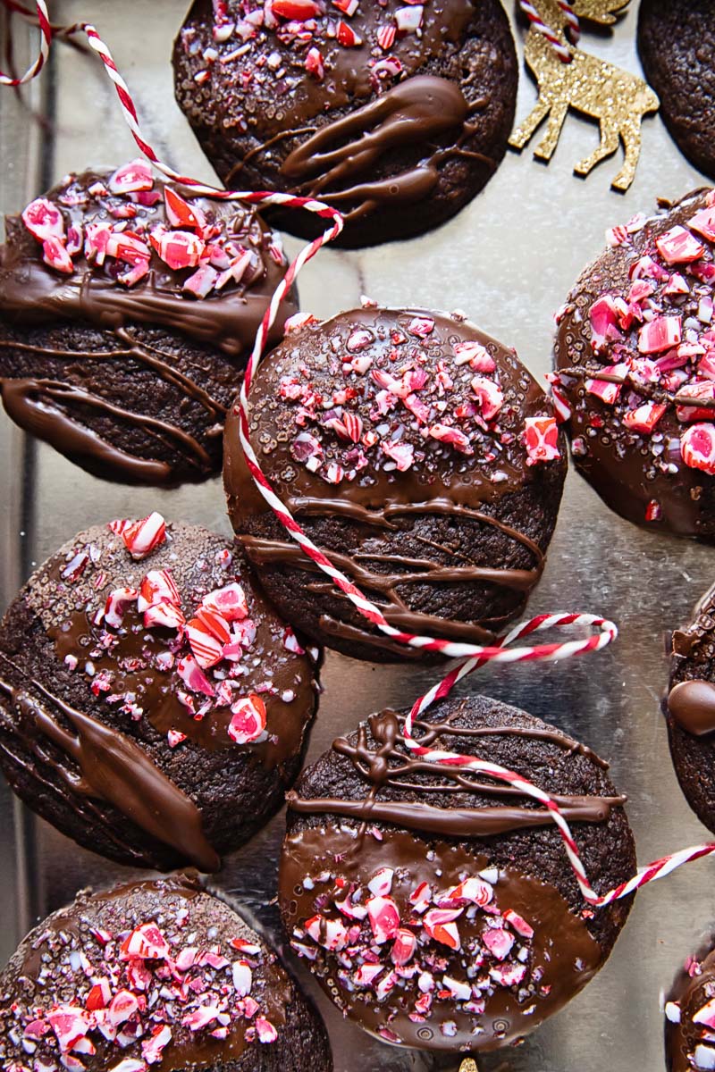 top down view of chocolate cookies drizzled with chocolate and top with crushed candy cane