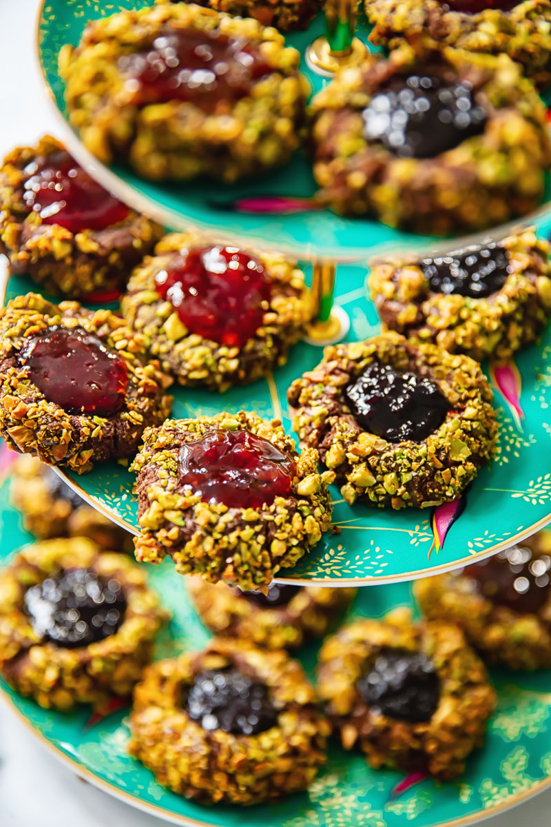 thumbprint cookies on a green tiered plate