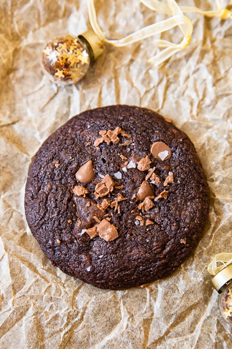 top down view of chocolate cookie and a mini Christmas tree ornament