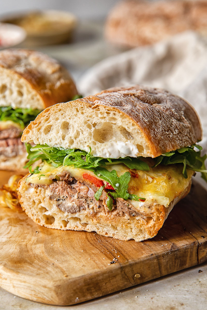 Hot roast beef sandwich on a wooden cutting board