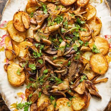 top down view of fried potatoes and mushrooms topped with herbs