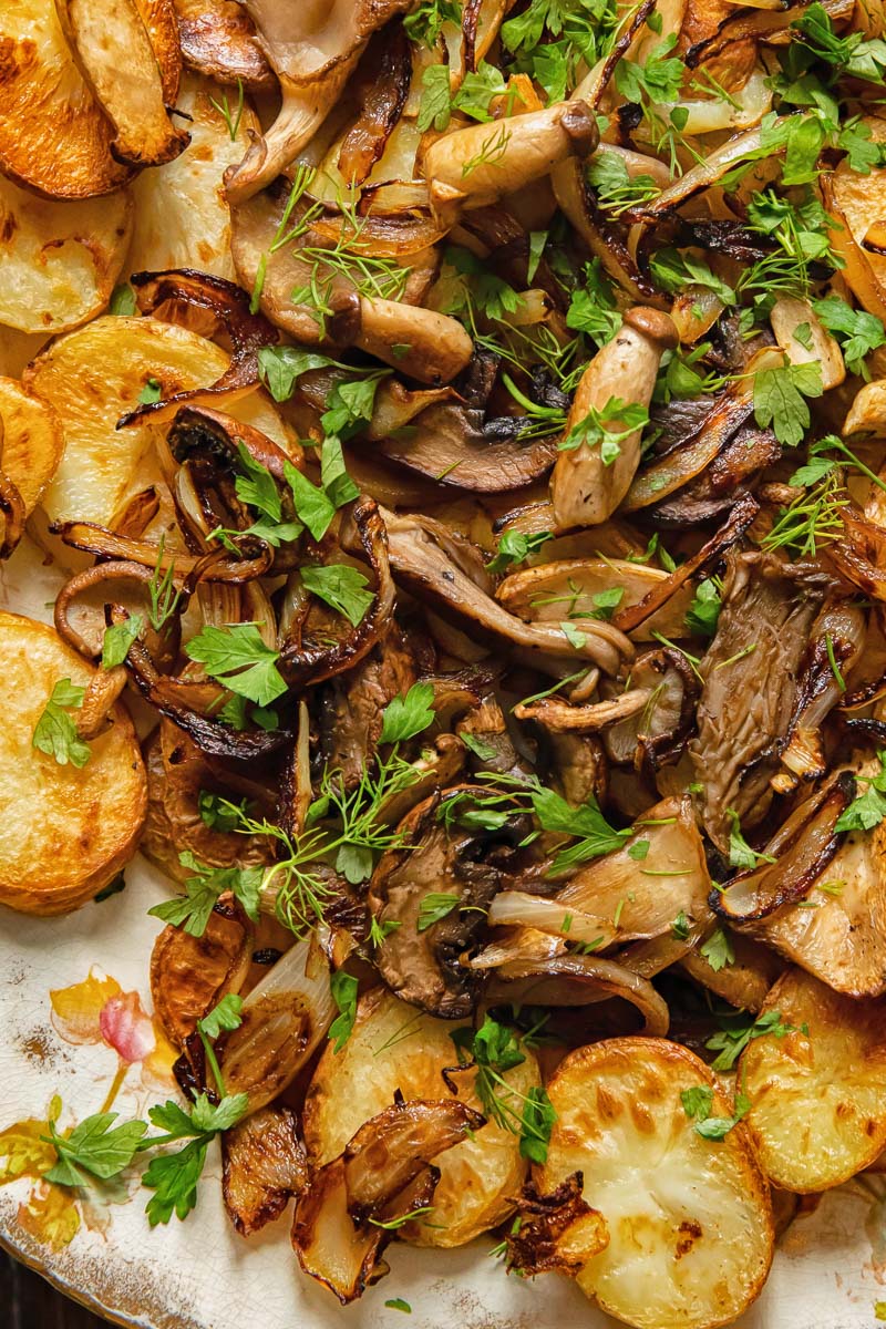 fried mushrooms on top of fried potatoes