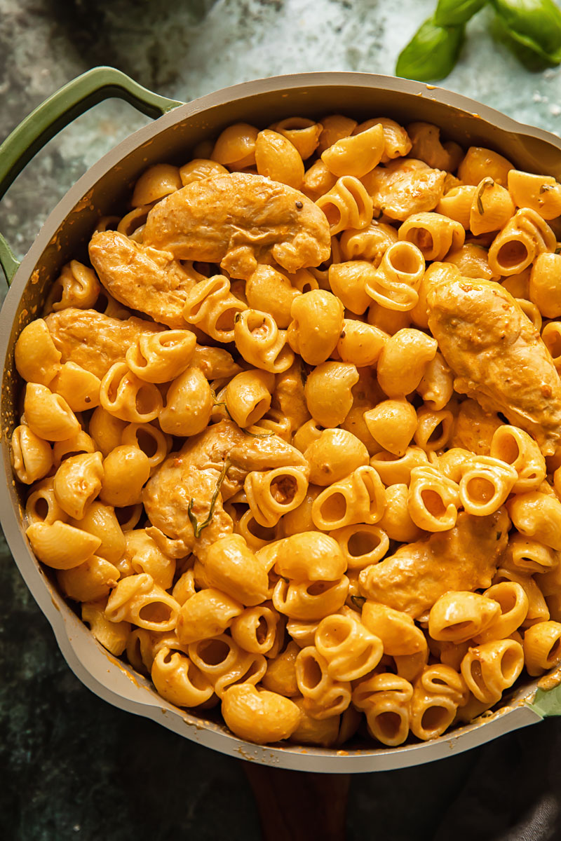 top dow view on a pasta dish in a pam on blue background