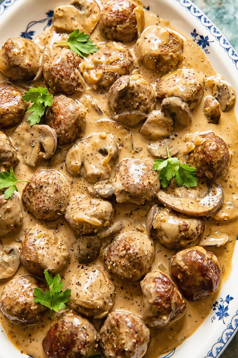 close up of meatballs and mushrooms in a creamy sauce